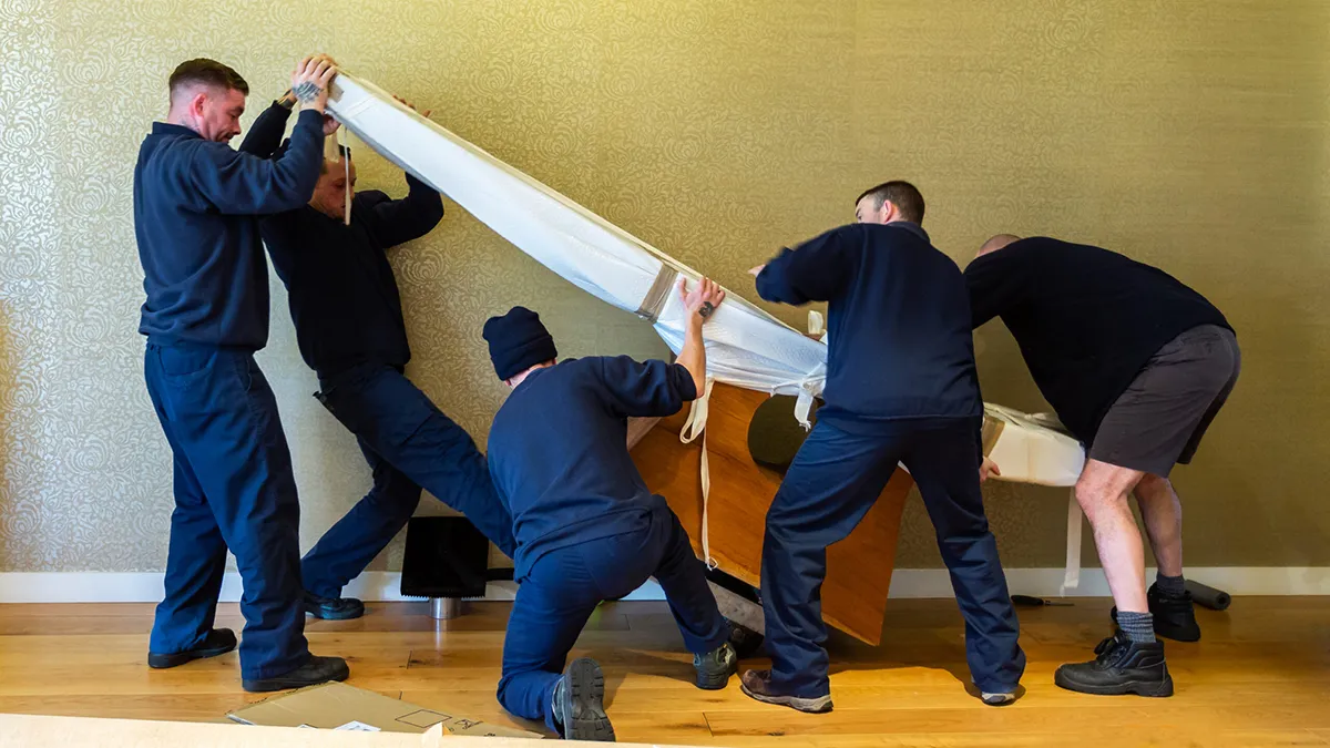 Move It Removals crew dismantling and loading office furniture Move It Removals dismantling office furniture during a business move in Essex